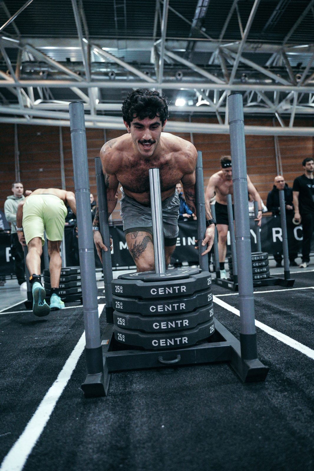Alon Shalev pushing a loaded sled in competition